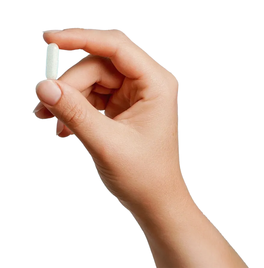 A hand holding a pill